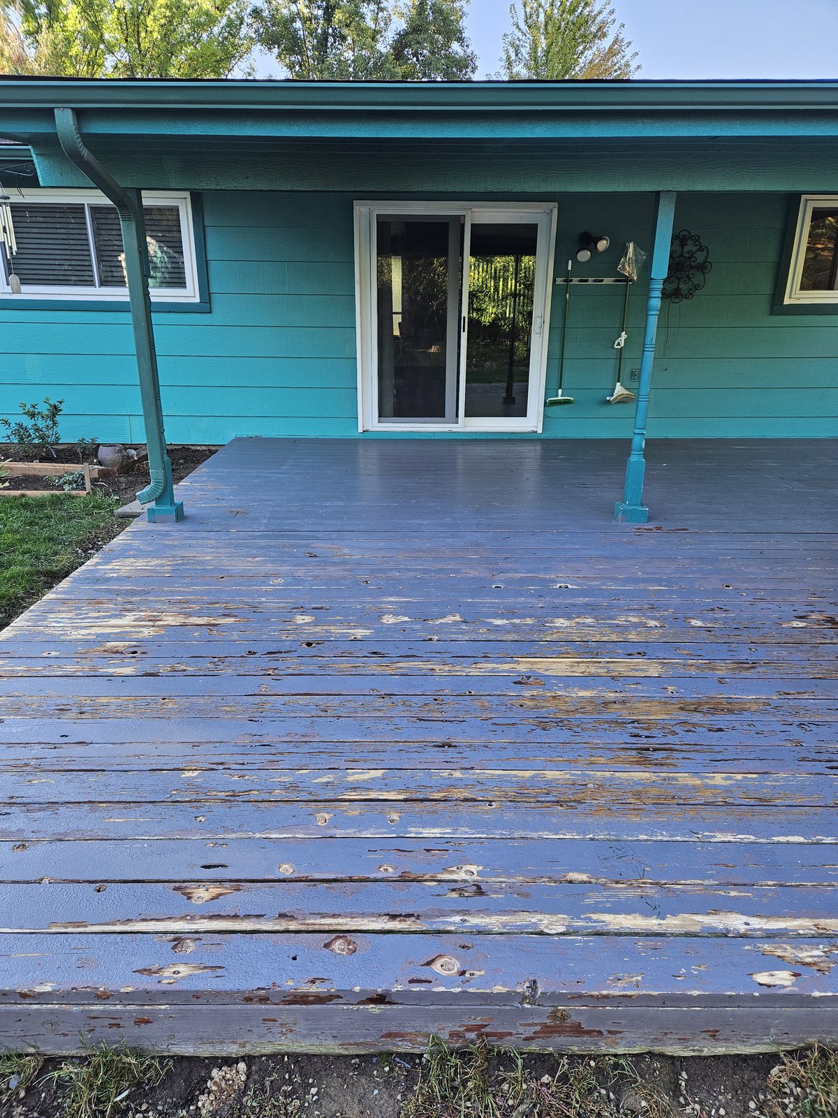 Worn, peeling blue-gray deck before restoration